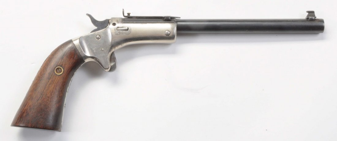 Stevens 6" Pocket Rifle Tip Up.: Serial No. 54067. Mfg from 1869-86. Standard features include a 6” part round barrel, single shot, 22 short/long rimfire. Nickel plated frame 85% finish. Barrel retains most of the original blue. Fi