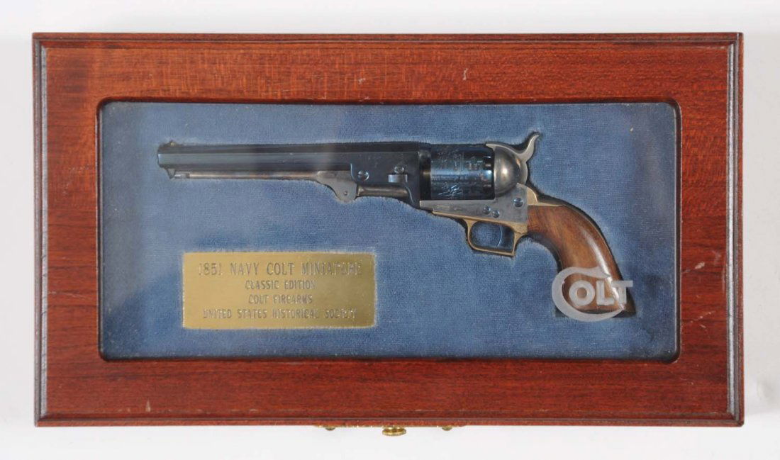 MIB U.S. Historical Society Colt 1851 Miniature: Serial No. 86. Gem mint miniature Colt Model 1851 Navy revolver in the Wood/glass Colt display case. Brass plague reads “1851 Navy Colt Miniature Classic Edition Colt Firearms United States Historic