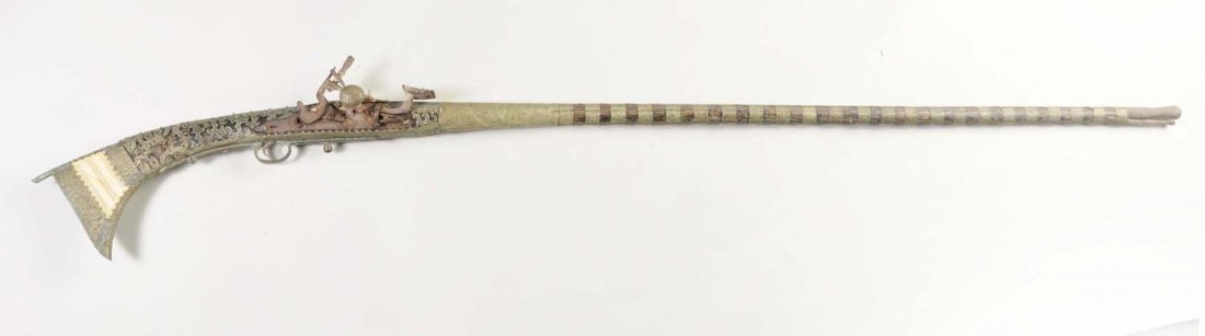 Early Middle Eastern Rifle.: This rifle is in relic condition. Clean metal, broken forestock, leather bands. Measures 68" long. Sold as decoration only.