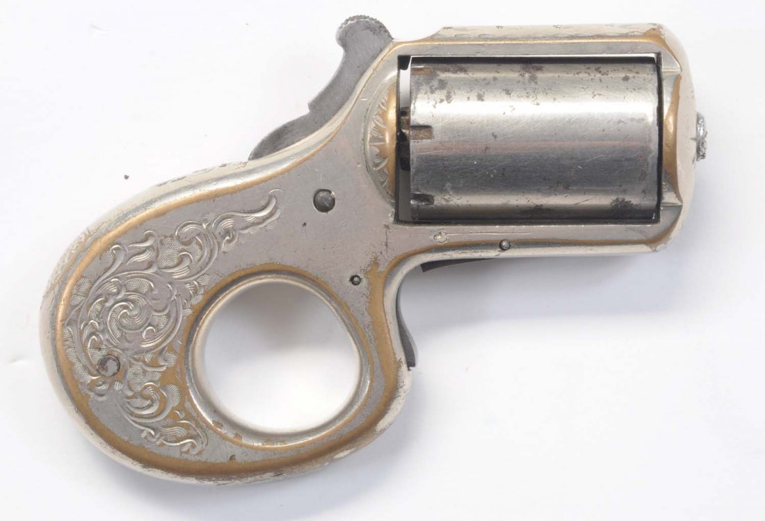 Reid "My Friend Knuckle Duster" Pistol.: Serial No. 13005. Fine condition. Retaining 70% nickel plating. .22 caliber. Cylinder does not index.
