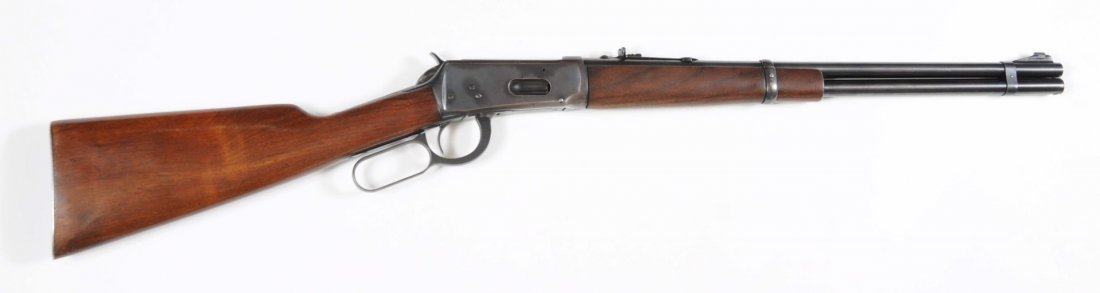 Winchester Model 1894 War Era Flat Band Carbine**: Serial No. 1445560. This carbine, manufactured between 1943-48 with a standard 20" round barrel, full magazine, ramp front sight, and steel shotgun buttplate. The barrel and tube retain approximately 