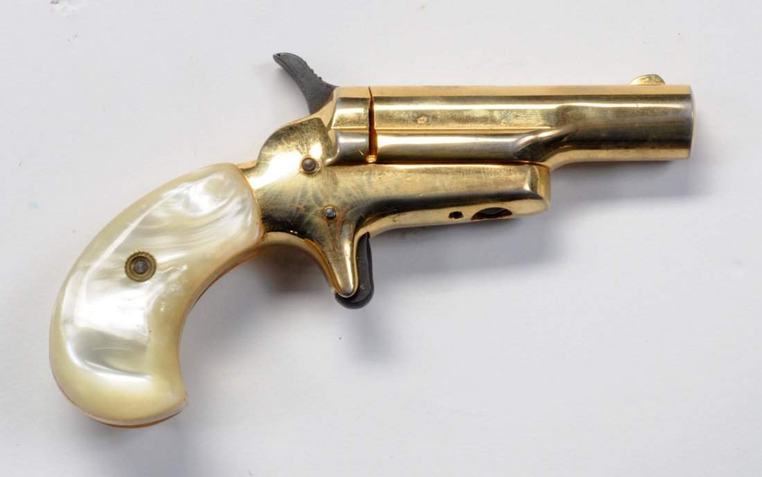 Butler Arms Colt 3rd Model Deringer Copy.**: Serial No. B42738. .22 short caliber. 2-1/2" barrel, pivots to the right. Gold plated, faux pearl grips. Mint bore and action. Near new.