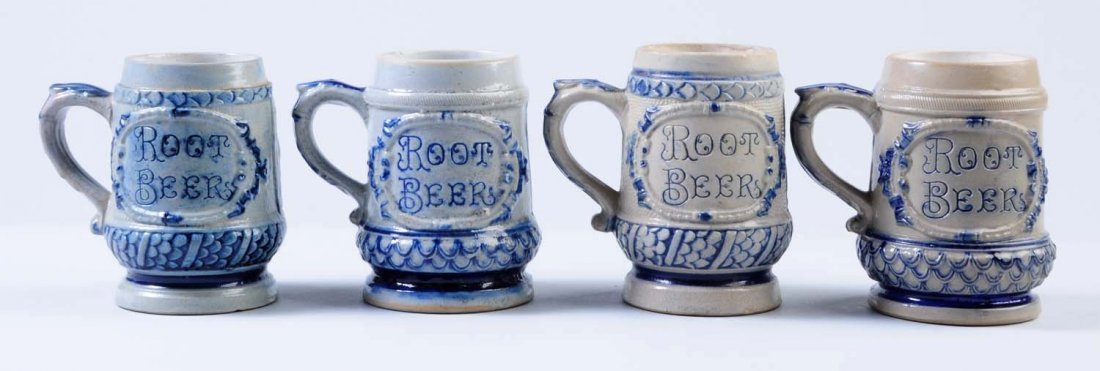 Lot of 4: Blue Decorated Stoneware Root Beer Mugs: These four mugs appear to be fairly nice overall. There are some areas of crazing, and one does have a small chip at the base. Condition (Very Good Plus). Size Each: 5" T.