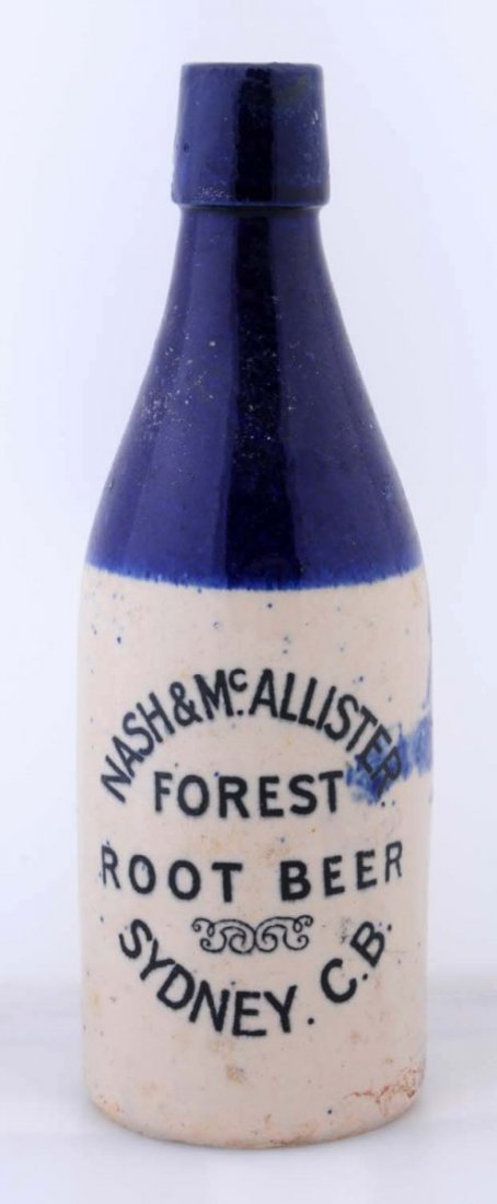 Nash & Mcallister Forest Stoneware Bottle.: This root beer bottle is decorated in blue and is from Sydney, C.B. Condition (Very Good Plus). Size 8 - 1/2" T.
