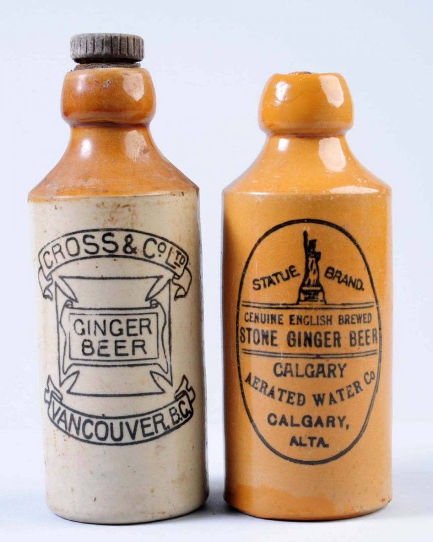 Lot of 2: Stoneware Ginger Beer Bottles.: The first bottle is marked "Cross & Co. Ginger Beer Vancouver, B.S." The second bottle is marked "Statue Brand Stone Ginger Beer Calgary, Alberta" This bottle has an illustration of the Statue of Libe