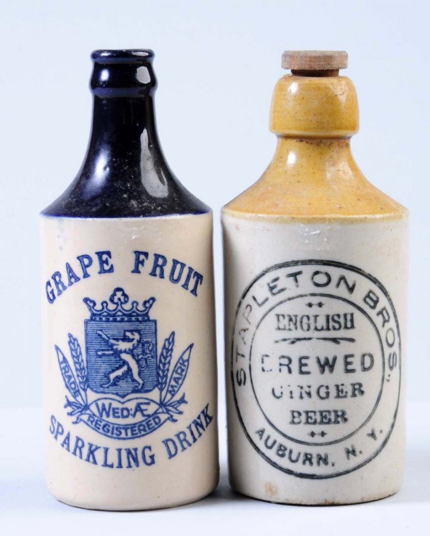 Lot of 2: Stoneware Beverage Bottles.: The first bottle is marked "Stapleton Brothers English Brewed Ginger Beer Auburn, NY." The second bottle is marked "Grapefruit Sparkling Drink". Condition (Excellent). Size Each: 7" T.