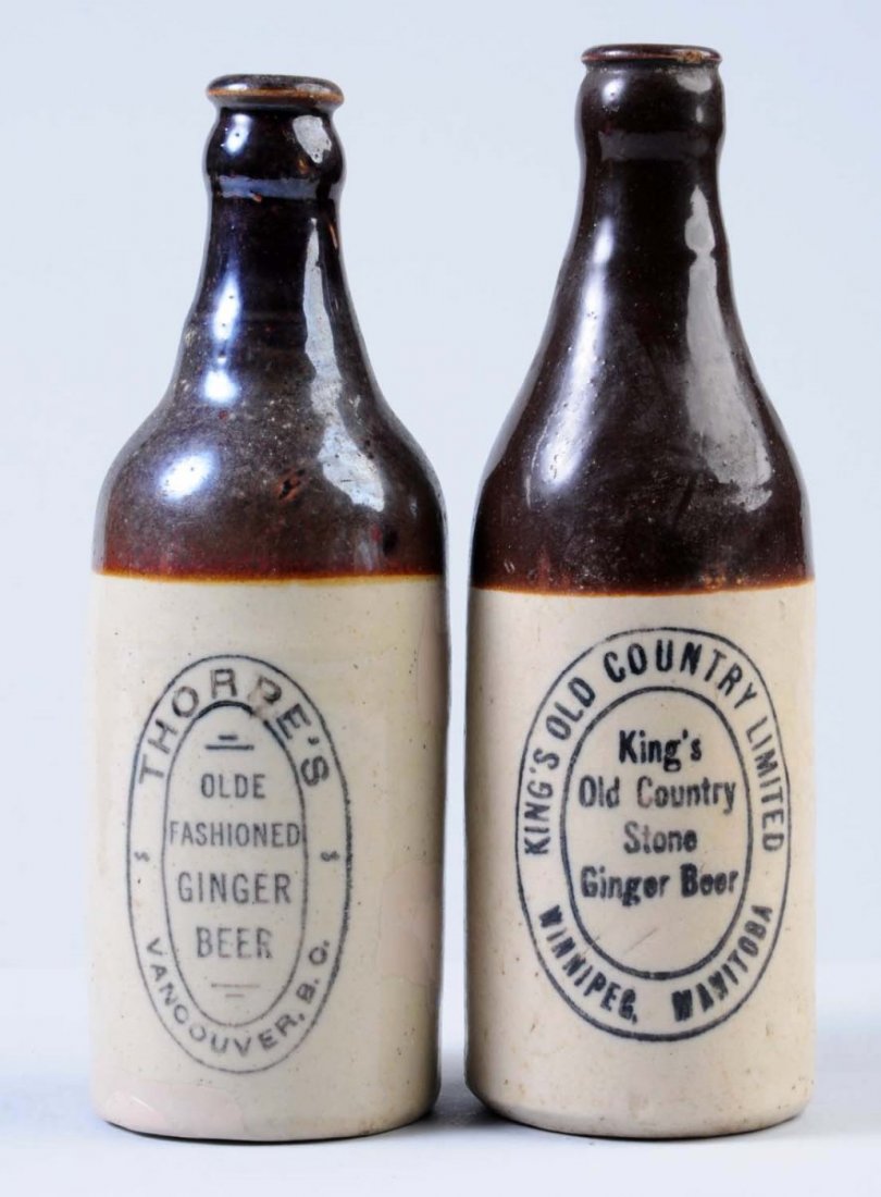 Lot of 2: Stoneware Ginger Beer Bottles.: The first bottle is marked "Kings Old Country Stone Ginger Beer Winnipeg, Manitoba." The second bottle is marked "Thorpe's Old Fashion Ginger Beer Vancouver, B. C." This bottle has multiple small area
