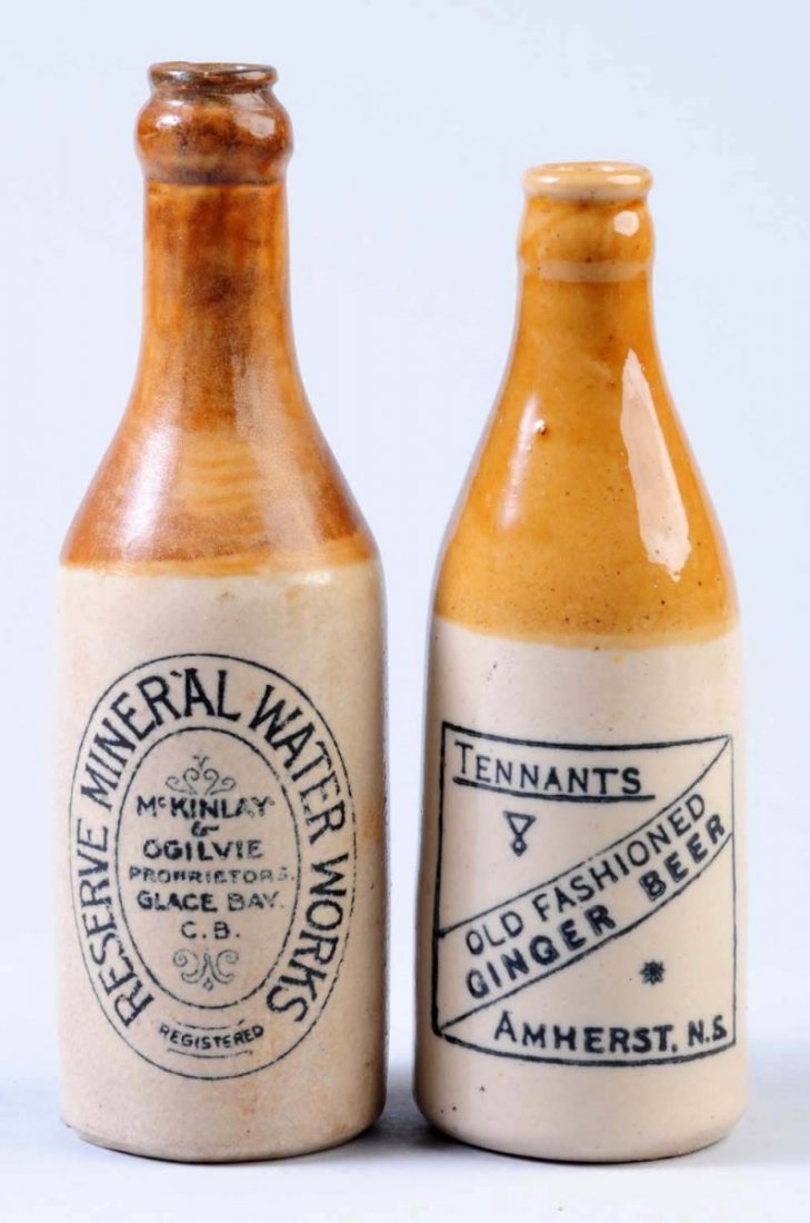 Lot of 2: Stoneware Beverage Bottles.: First bottle marked "Tennants Ginger Beer Amherst, N.S.". Second bottle is marked " McKinlay & Ogilvie reserve mineral water works". Condition (Very Good Plus). Size Each: 8 - 1/4" T.