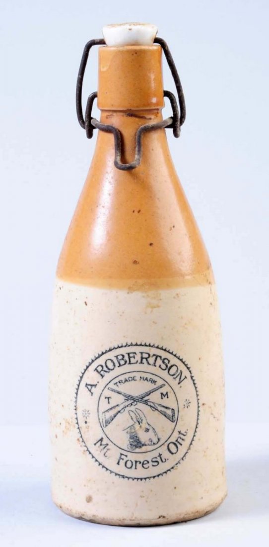 A. Robertson Stoneware Beer Bottle: Depicts two guns and a rabbit and is from Mount Forest, Ontario. Some overall soiling. Condition (Very Good Plus). Size 9" T.