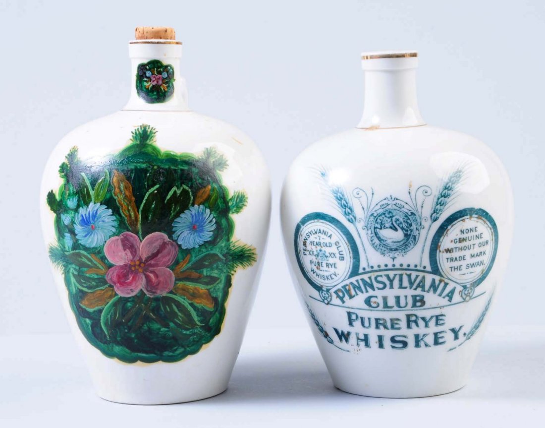 Lot of 2: China Whiskey Jugs.: One jug appears to have hand painted decorations, and the other was put out by Pennsylvania Club Pure Rye Whiskey. Both jugs have minor staining here and there. Condition (Very Good Plus). Size Each: