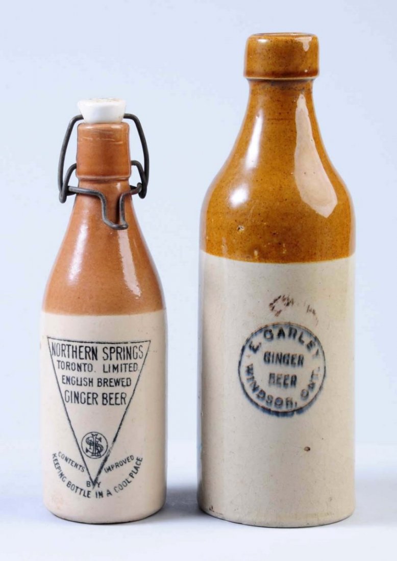 Lot of 2: Stoneware Ginger Beer Bottles.: The larger bottle advertises "E. Carley Ginger Beer" from Windsor, Ont. The second bottle advertises "Northern Springs English Brewed Ginger Beer" from Toronto. Condition (Excellent). Size Largest: 10