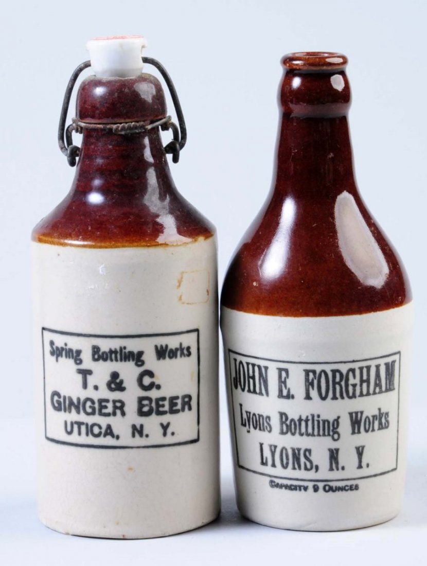 Lot of 2: Stoneware Beverage Bottles.: First bottle is marked "T & C Ginger Beer Utica, NY." Second bottle is marked "John E. Forgham Lyons Bottling Works Lyons, NY. " Condition (Excellent). Size Largest: 8" T.