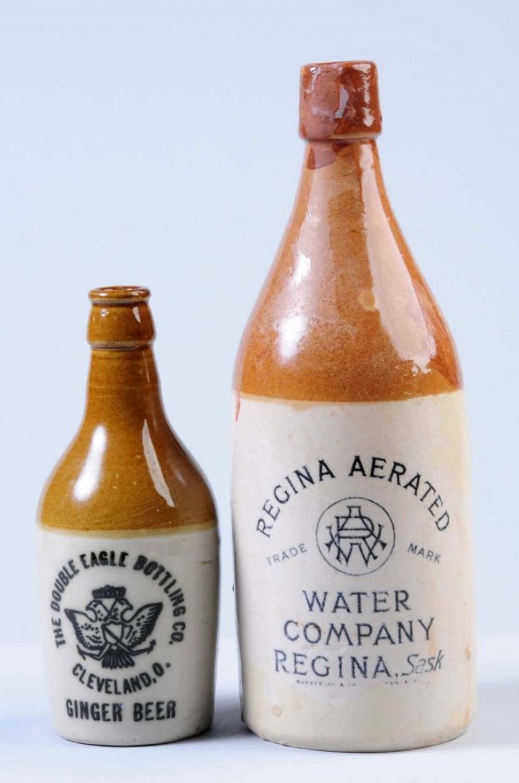 Lot of 2: Stoneware Beverage Bottles.: The first bottle is marked " The Double Eagle Bottling Co. Ginger Beer Cleveland, OH." The second bottle is marked "The Regina Aerated Water Co." This bottle may have some sort of restoration. Conditi