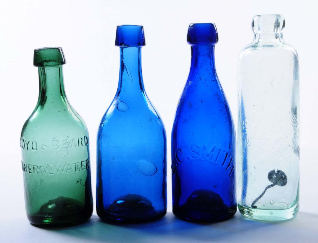 Lot of 4: Early Bottles.: This lot includes: a Star Bottling Works bottle from South Sharon, PA and a cobalt L.C Smith bottle, a green Boyd and Beard bottle and an unmarked bottle. Condition (Very Good Plus). Size Largest: 8" 