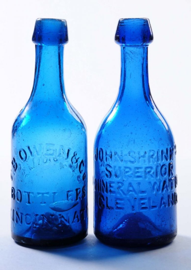 Lot of 2: Early Bottles - Ohio.: This lot includes: a C.B Owen and Co. blue bottle from Cincinnati and a blue from John Shrinks in Cleveland. The Shrinks bottle has some contact scraping. Condition (Very Good Plus). Size Each: 7 - 1/