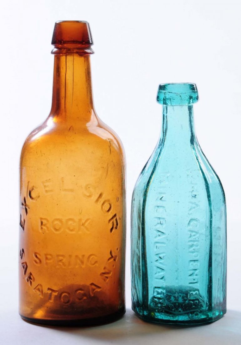 Lot of 2: Early Bottles - New York.: This lot includes: a turquoise octagon bottle from WM. A. Carpenter's in Hudson and a larger amber bottle from Excelsior Rock Spring in Saratoga. Condition (Very Good Plus). Size Largest: 9" T.