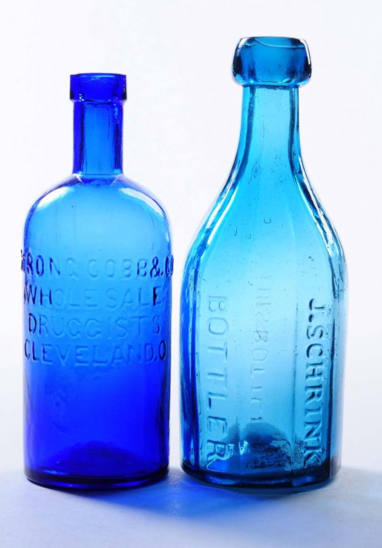 Lot of 2: Early Bottles - Cleveland, Ohio.: This lot includes: a cobalt Strong Cobb and Co. medicine bottle and a blue green octagon bottle from J. Schrink. Condition (Excellent). Size Largest: 7 - 1/4" T.