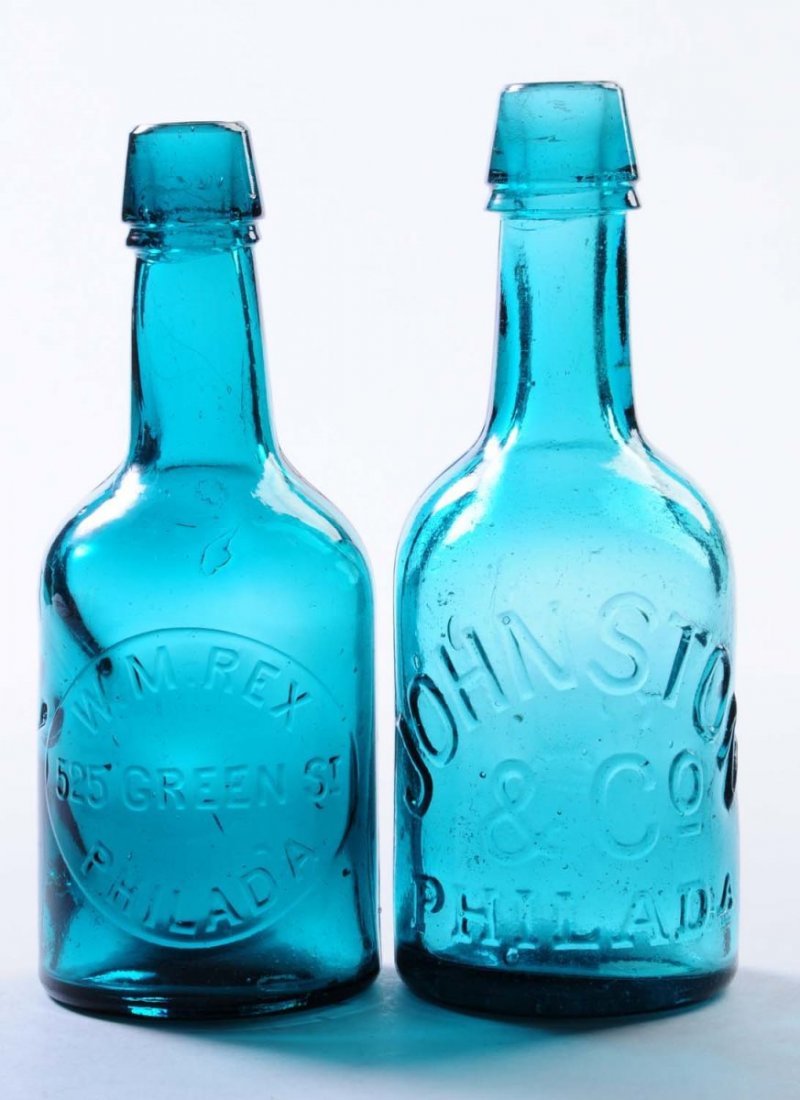Lot of 2: Early Beer Bottles - Philadelphia.: This lot includes: a turquoise bottle from Johnston and Co. and another turquoise bottle from W.M Rex. Condition (Excellent). Size Largest: 7 - 1/2" T.