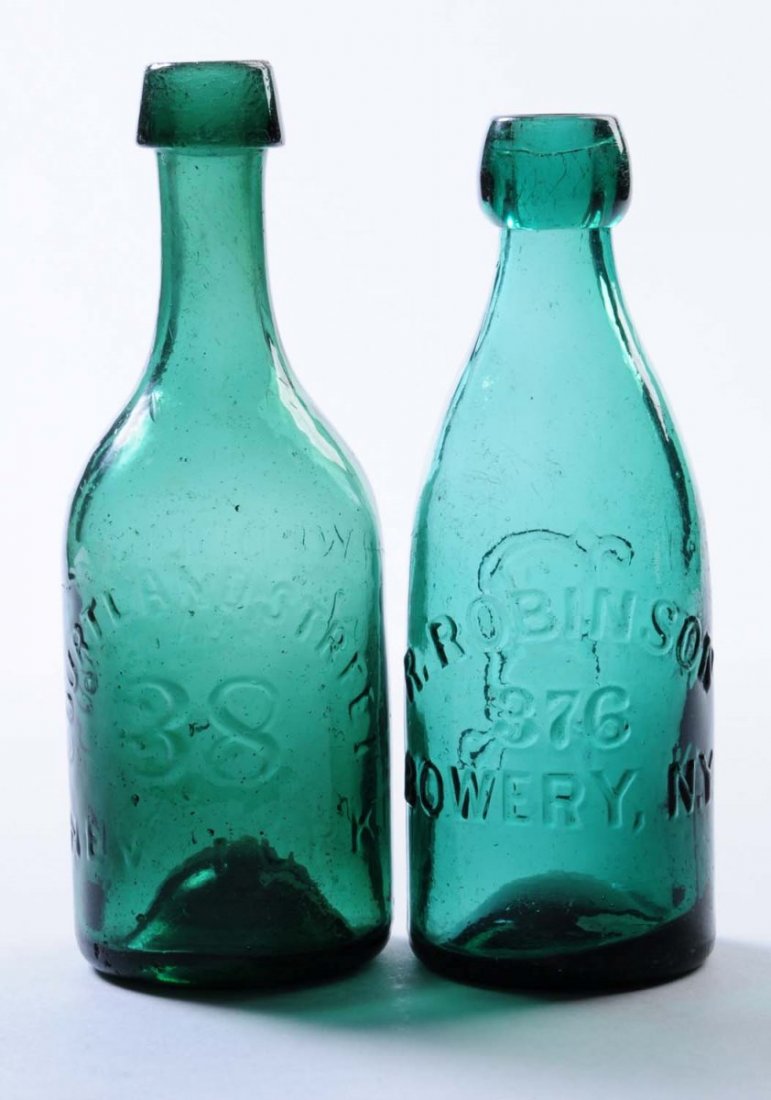 Lot of 2: Early Beer Bottles - New York.: This lot includes: a green blue bottle from R. Robinson, The Bowery New York and another green blue bottle from T. Weddles. Condition (Excellent). Size Largest: 7 - 1/2" T.