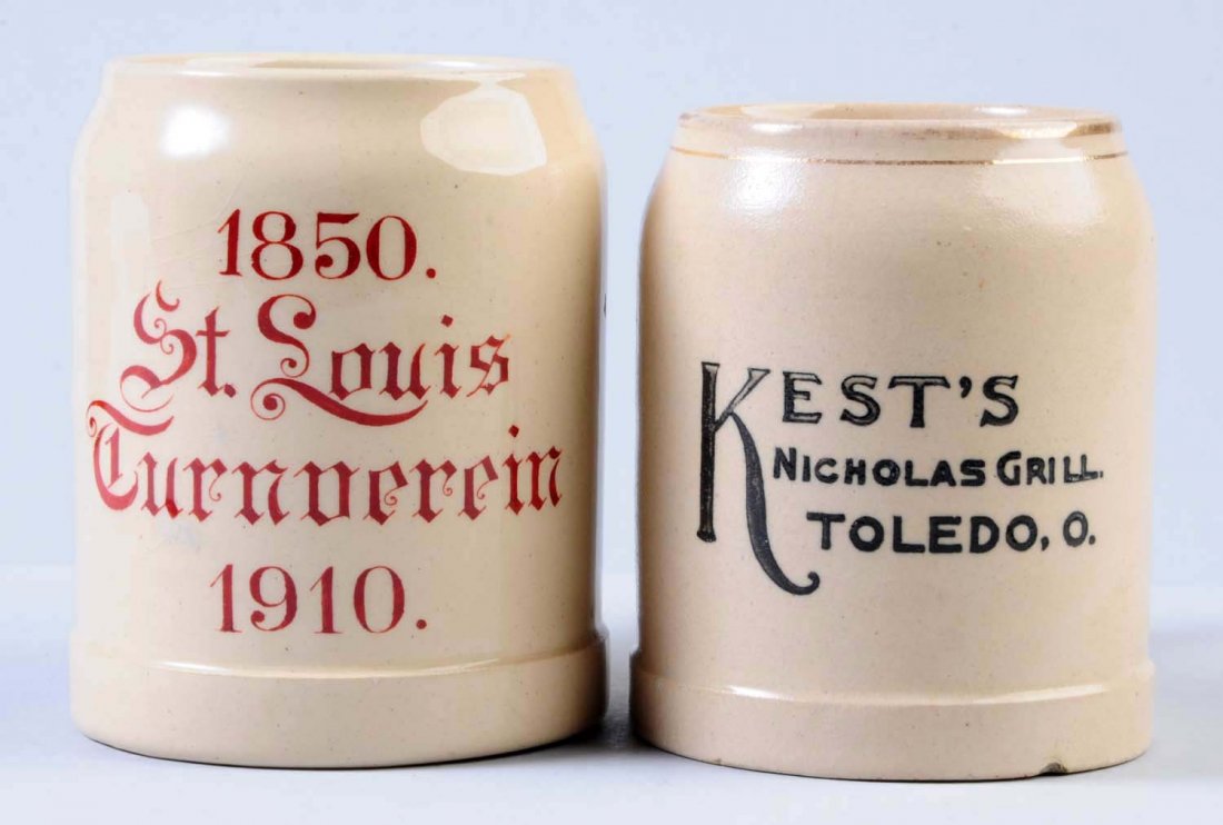 Lot of 2: Root Beer Mugs.: One mug is marked "1850 St. Lois Turnoerein 1910". This mug has some very minor crazing. The second mug is marked "Kest's Nicholas Grille Toledo, O." This mug has one small chip at the base but otherw