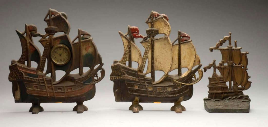 Lot of 3: Cast Iron Assorted Ship Doorstops.: One ship is a mantel piece with clock, not working. Condition (Good). Size Tallest: 11 - 3/4" T.