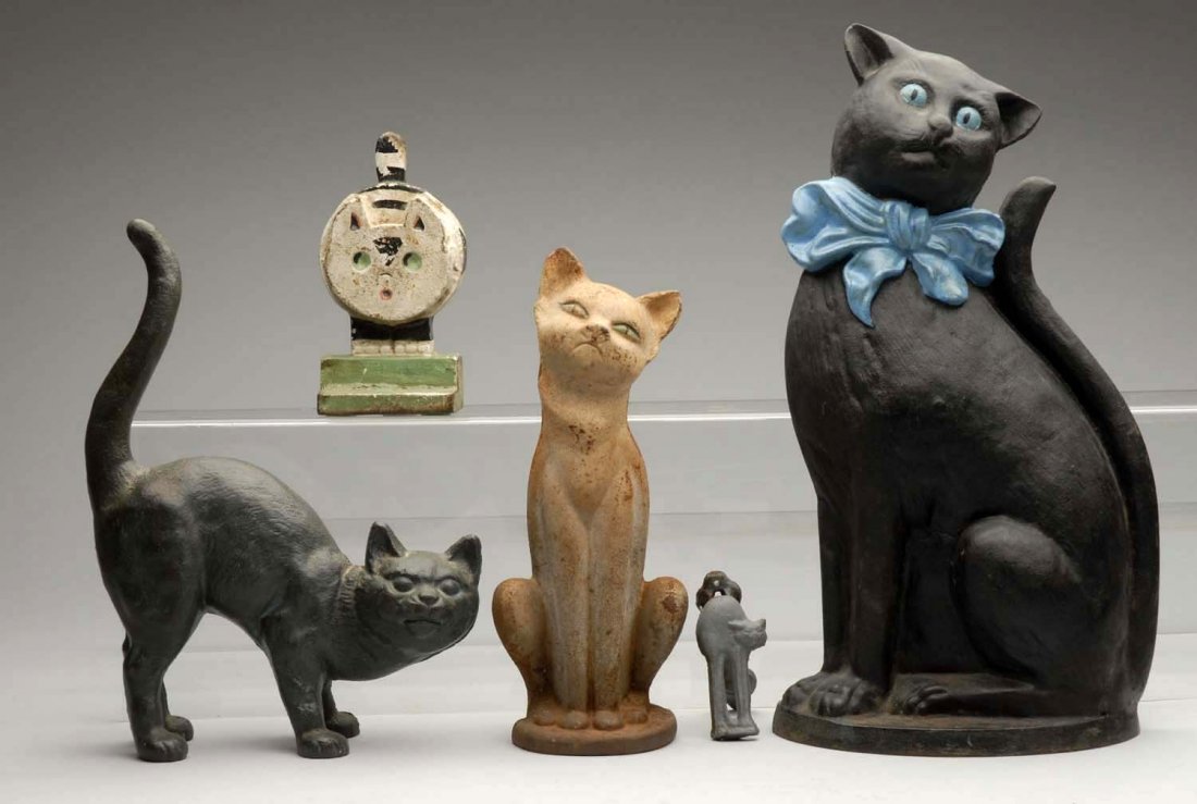 Lot of 5: Cast Iron Assorted Cats.: Lot contains doorstops and doorknocker. Cat with bow doorstop and cat doorknocker repainted. Hump back cat and wedge cat are reproductions. Condition (Good). Size Tallest: 13 - 3/4" T.