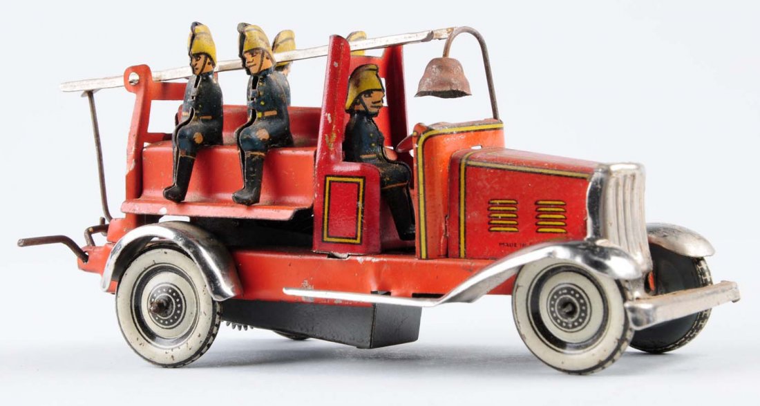 German Tin Wind-Up Fire Truck Penny Toy.: Includes four firemen plus a driver. Condition (Very Good - Excellent). Size 4" L.