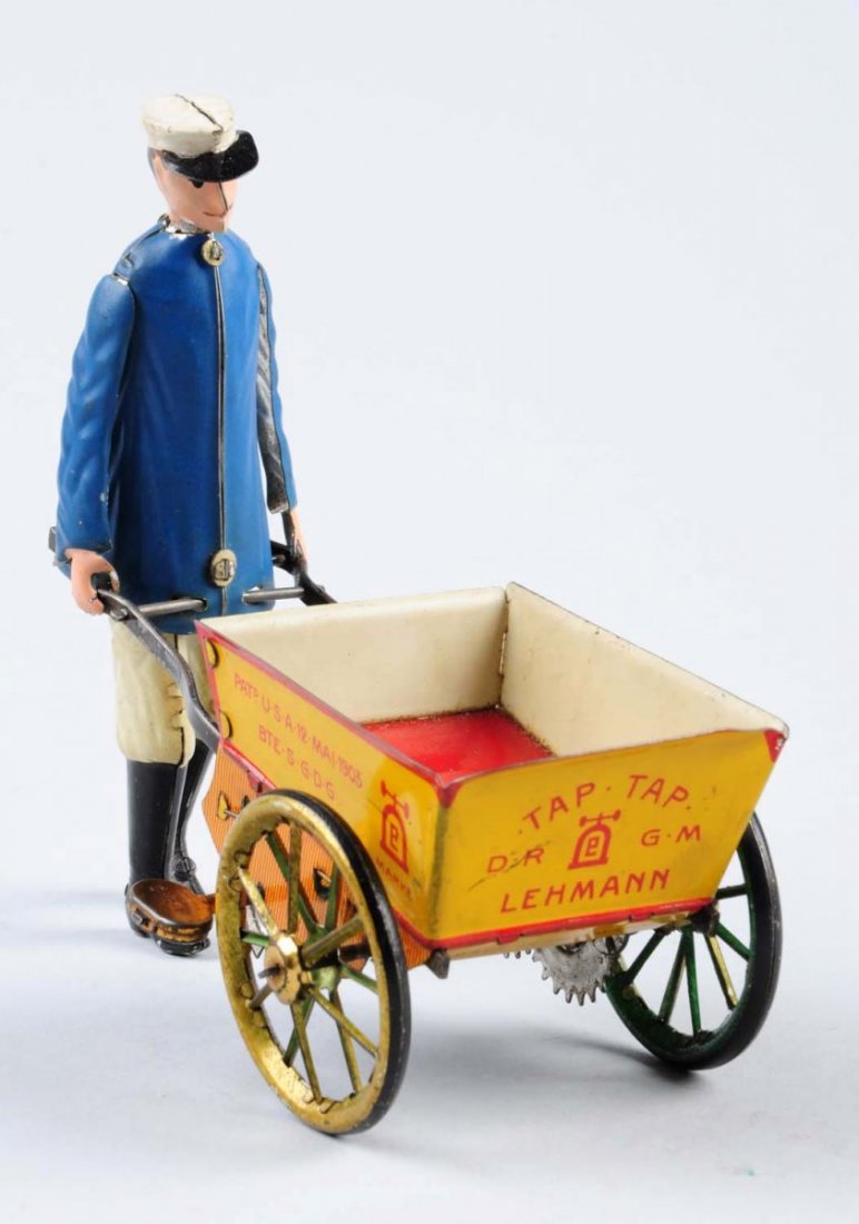 Lehmann Tin Wind-Up Man Pushing Wagon.: Has a few scratches throughout as well as some litho loss. Very attractive toy. Condition (Very Good - Excellent). Size 6" L.