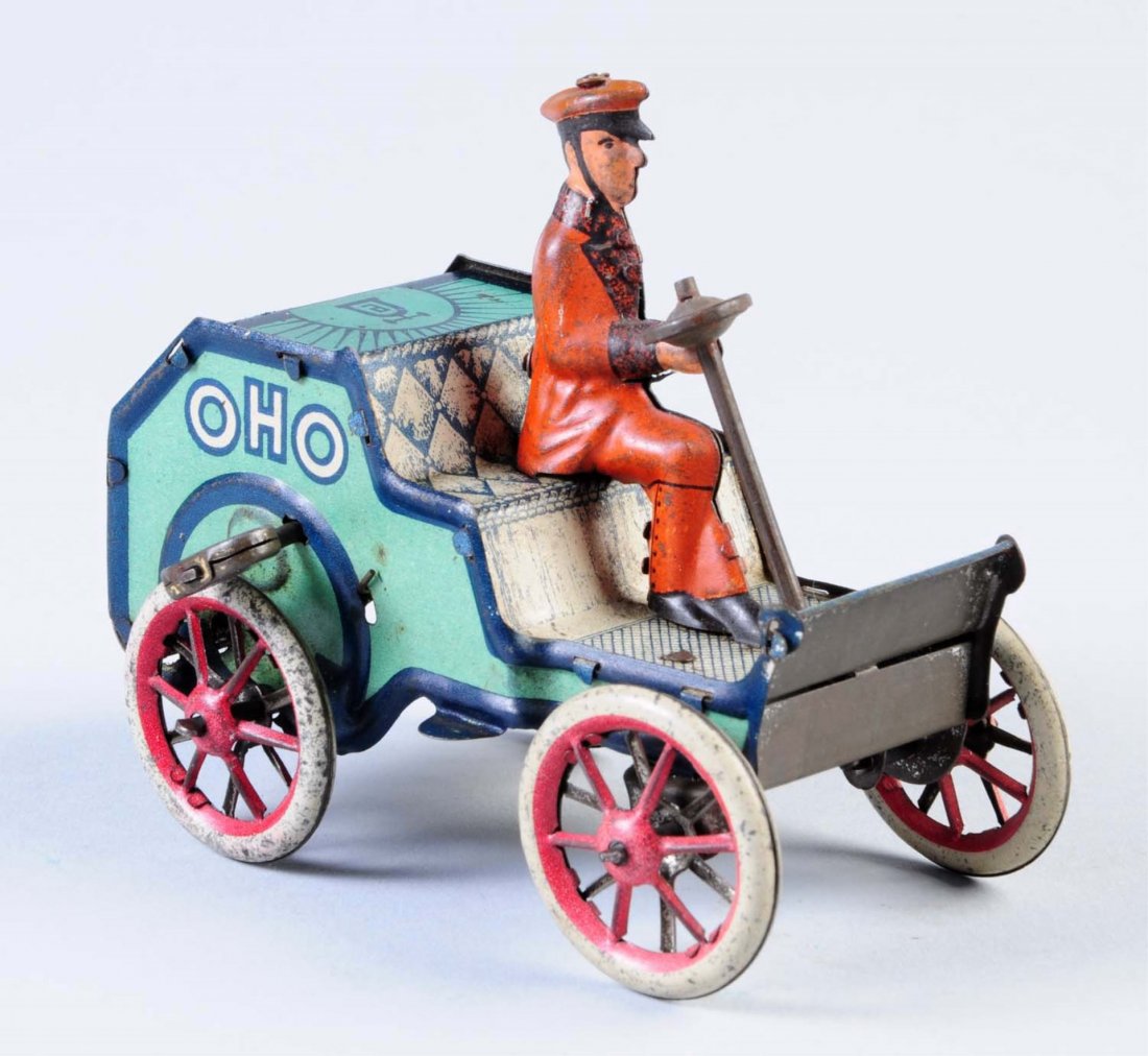 Tin Wind-Up OHO Car.: Made in Germany. Has good amount of scratches and litho loss. Includes original key and steering wheel. Car is marked "OHO" on both sides. Condition (Very Good - Excellent). Size 4" L.