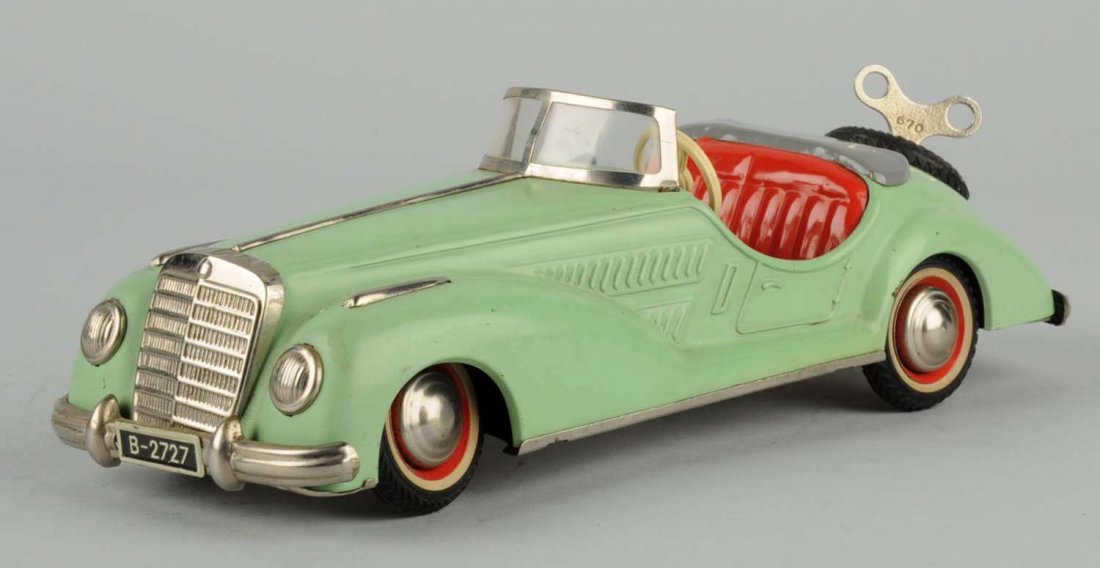 Tin Wind-Up Car.: There are a couple of many minor paint scratches throughout the car. Includes original key. No scratches or cracks to the windshield. Condition (Excellent - Near Mint). Size 9 -1/2" L.