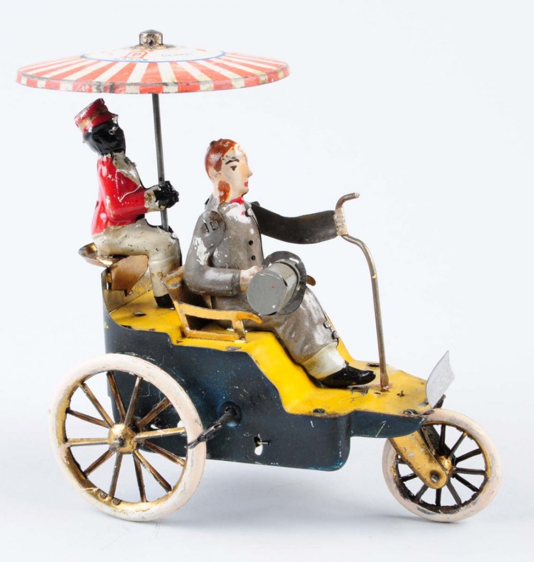 Wind - Up Tin Toy.: Rickshaw with driver and passenger. Tin litho scratches. Rickshaw appears to be repainted as well as the outer tin wheels. Rickshaw driver has moving arms. Passenger is holding an umbrella. Condition