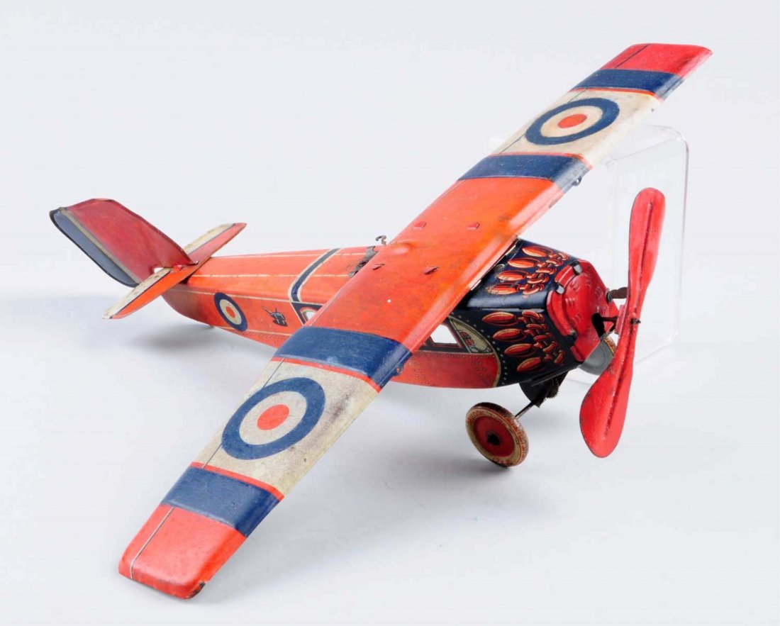 German Tin Wind - Up Airplane.: Some litho loss and chips. Comes with original wind - up key and tin wheels. Has nice graphics. Condition (Good - Very Good). Size 16" L.