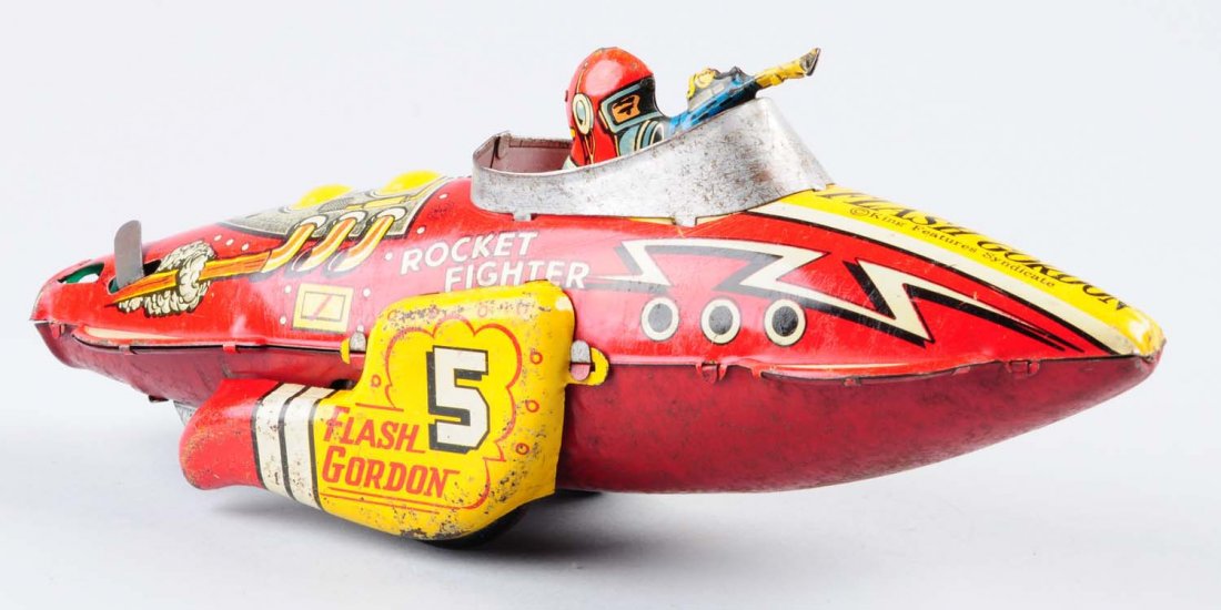 Marx Tin Wind - Up Rocket Fighter.: Toy has significant tin litho deterioration, chips and scratches throughout toy. Remaining litho colors are very attractive and bright. Comes with original wind - up key. Condition (Good). Size 12" L.