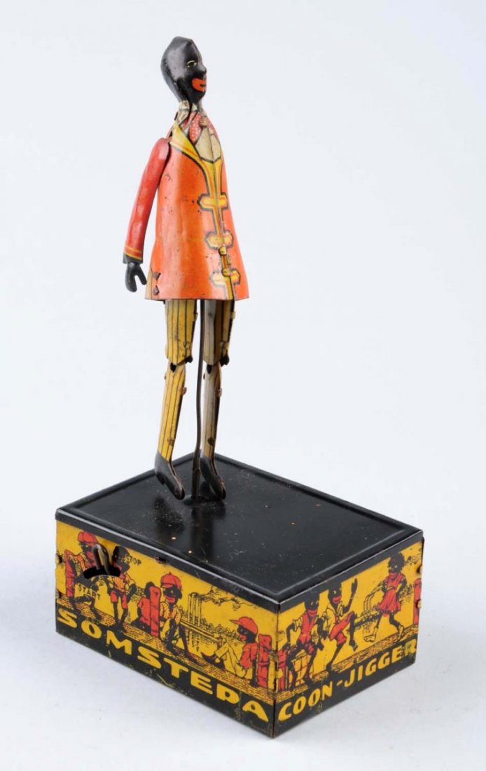 Marx Tin Wind - Up Somstepa Coon Jigger.: Toy has some litho scratches throughout. Remaining colors are still very attractive for a toy this age. Jigger is dancing on a tin platform, side panels of the platform has colorful graphics of people
