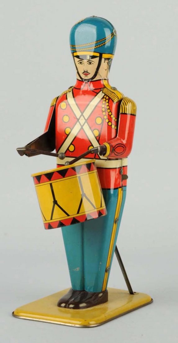 Wolverine No. 27 Tin Wind-Up Drum Major.: Toy has small areas of scratches throughout the toy. Otherwise, it has nice bright colors. Includes original wind-up key and tin drumsticks, Condition (Very Good - Excellent). Size 14" L.