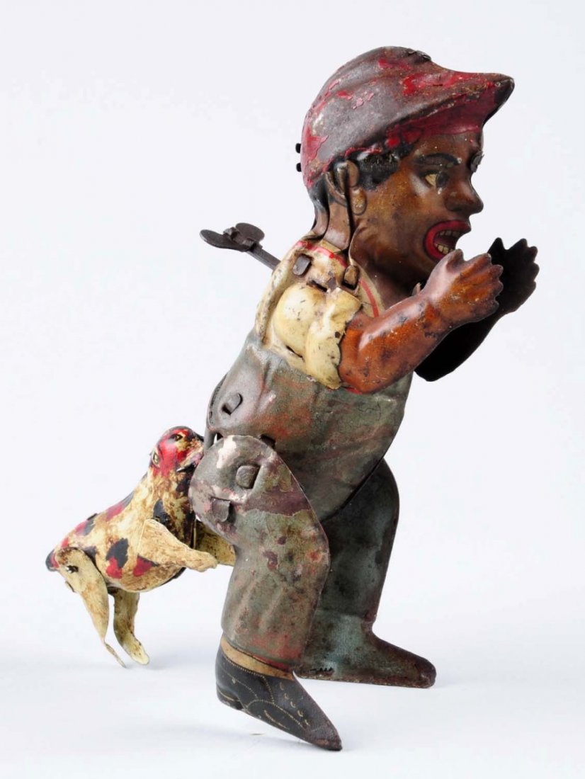 Wind - Up Boy With Dog Tin Toy.: Toy has significant litho scratches and paint loss throughout. Remaining litho color is visible and still shows the beauty of the toy. Condition (Good). Size 6 -1/2" T.CORRECTION: The dog has been rep