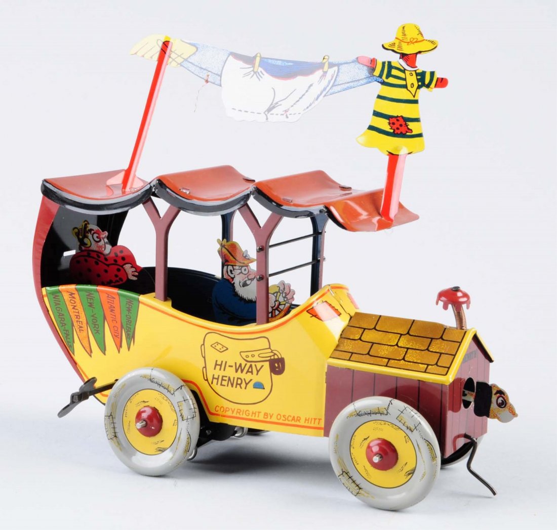 Tin Wind - Up Truck Called "Hi - Way Henry".: Has a lot of detail. Tin driver and passenger. Front section of truck is in the shape of a dog house, dog poking head out of dog house. Top of the house has interesting chimney made out of a spring. H