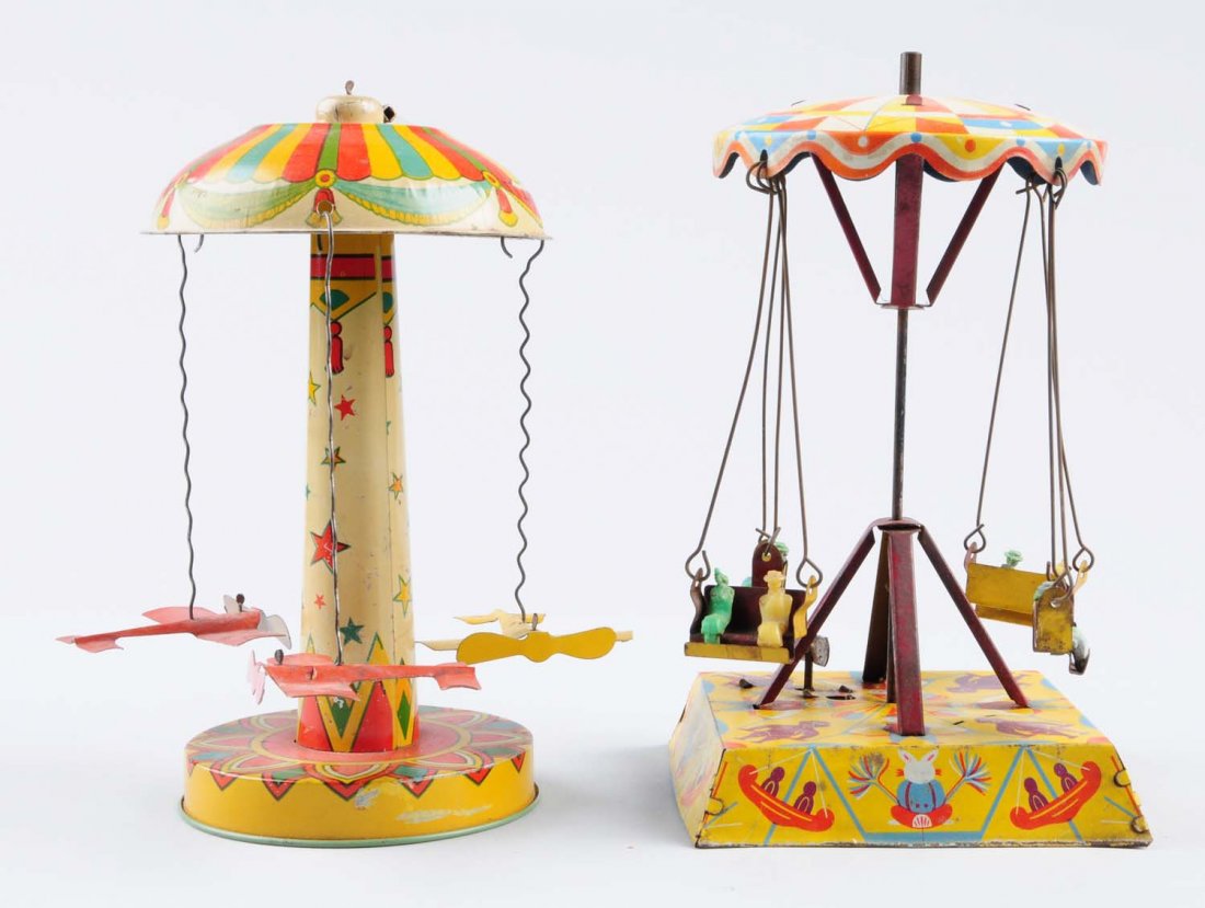 Lot Of 2: Tin Wind - Up Merry - Go - Round.: First one includes three tin airplanes. Also includes original key. Has significant scratching throughout. Planes have some scratches and slight oxidation on wings. Wind - up mechanism is in good shap
