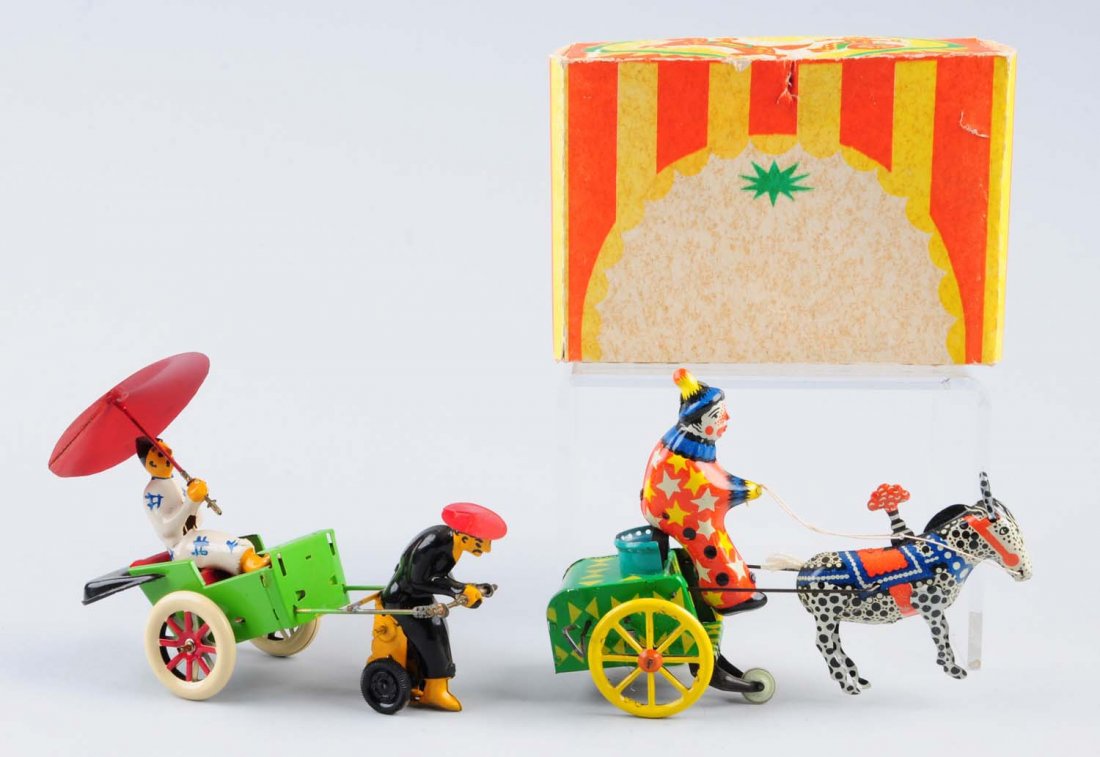 Lot of 2: Tin Wind - Up Toys One In a Box.: The toy that comes with a box is a donkey pulling a cart with a rider, the other toy is a person pulling a rickshaw with passenger in it. Both toys include original keys. No visible scratches or deter