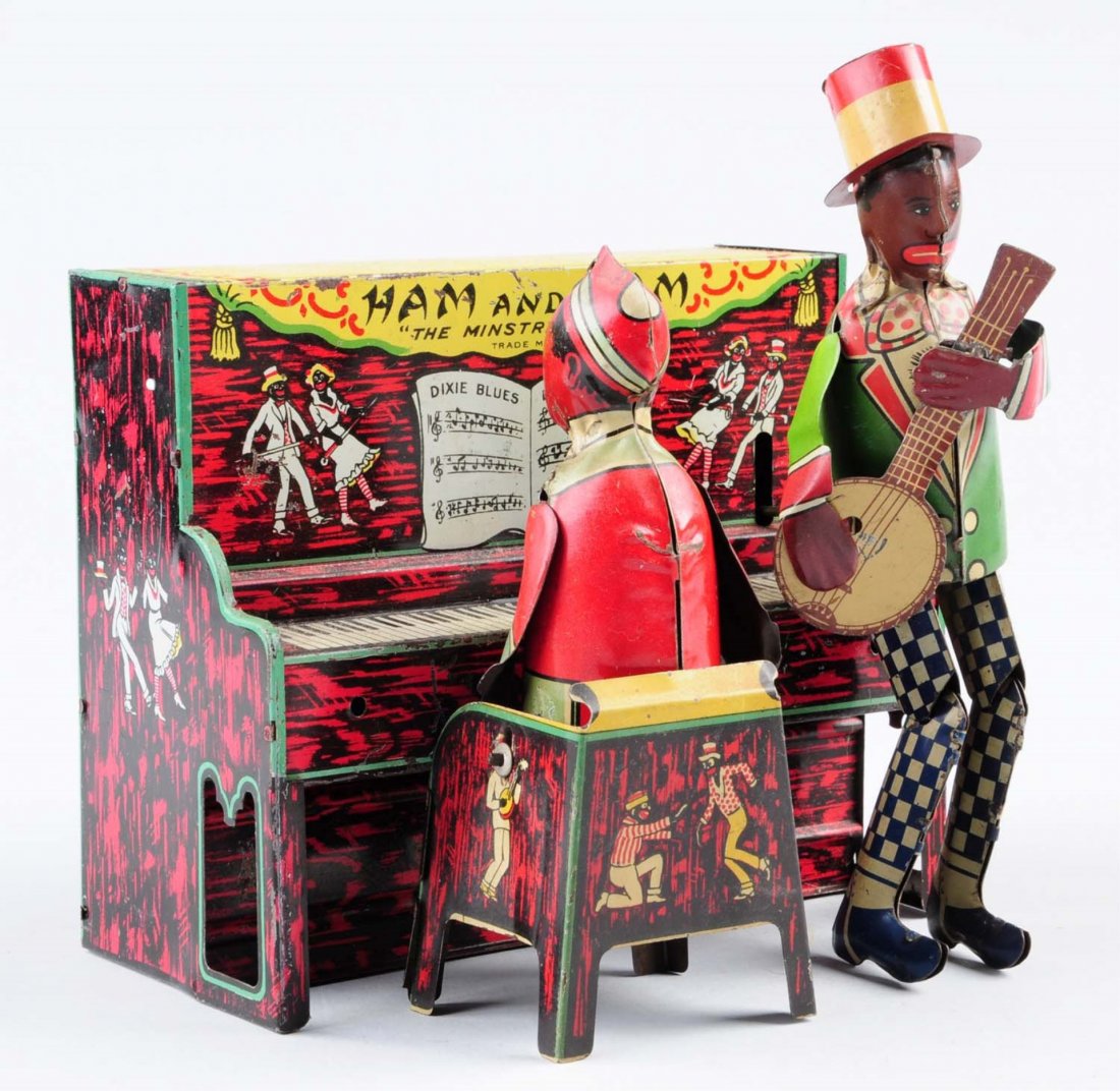 Tin Wind - Up Ham and Sam Toy.: Minor litho scratches and deterioration's throughout. Otherwise litho color is very attractive. Comes with original wind - up key. Condition (Very Good - Excellent). Size 6 -1/2" L.