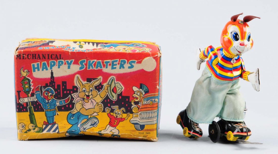 Tin Wind - Up Happy Skaters.: Minor scratches and oxidation. Otherwise the tin litho colors are very bright and attractive. Skater is wearing cloth pants. Comes with original box. Box has creasing and some paper tear. Condition (E