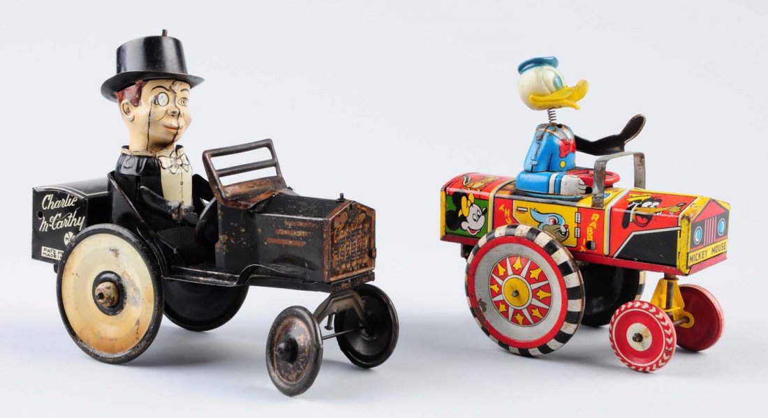Lot of 2: Tin Wind - Up Toys.: Both are made by Marx in the United States. One of them is a Donald Duck driving a car. and the other is a Charlie McCarthy driving a car. Both toys have significant scratches and chips and various sm