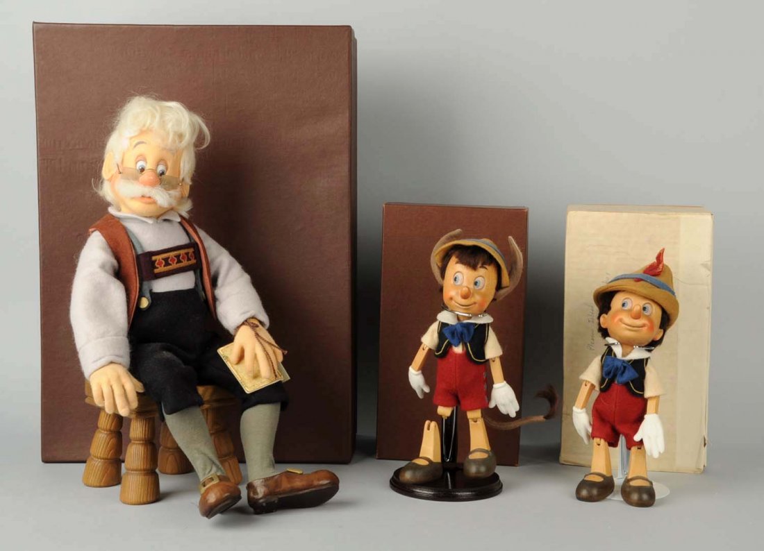 Lot of 3: Pinocchio Dolls in Boxes.: The first two are Wooden Pinocchio's with various clothing in original boxes. The third one is a larger doll; Geppetto and Pinocchio made by R. John Wright Dolls inc. Made is U.S.A. Dolls are made of 