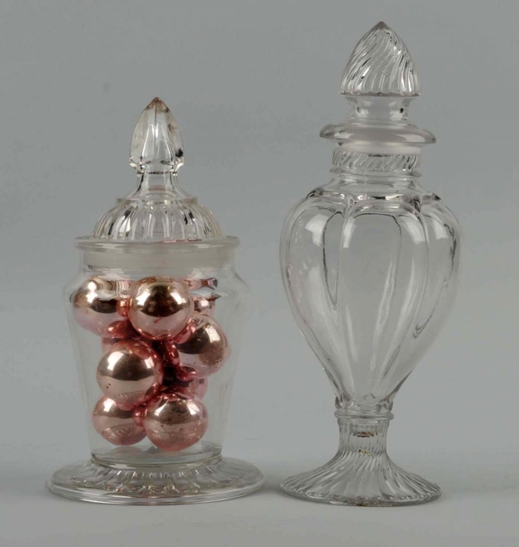 Lot of 2: Candy/Apothecary Jars.: Lot includes a pedestal swirl-paneled jar with a ground lid, and a Listerated Pepsid Gum jar with ground lid. Neither items have damage. Condition (Excellent). Size Largest : 13" T.