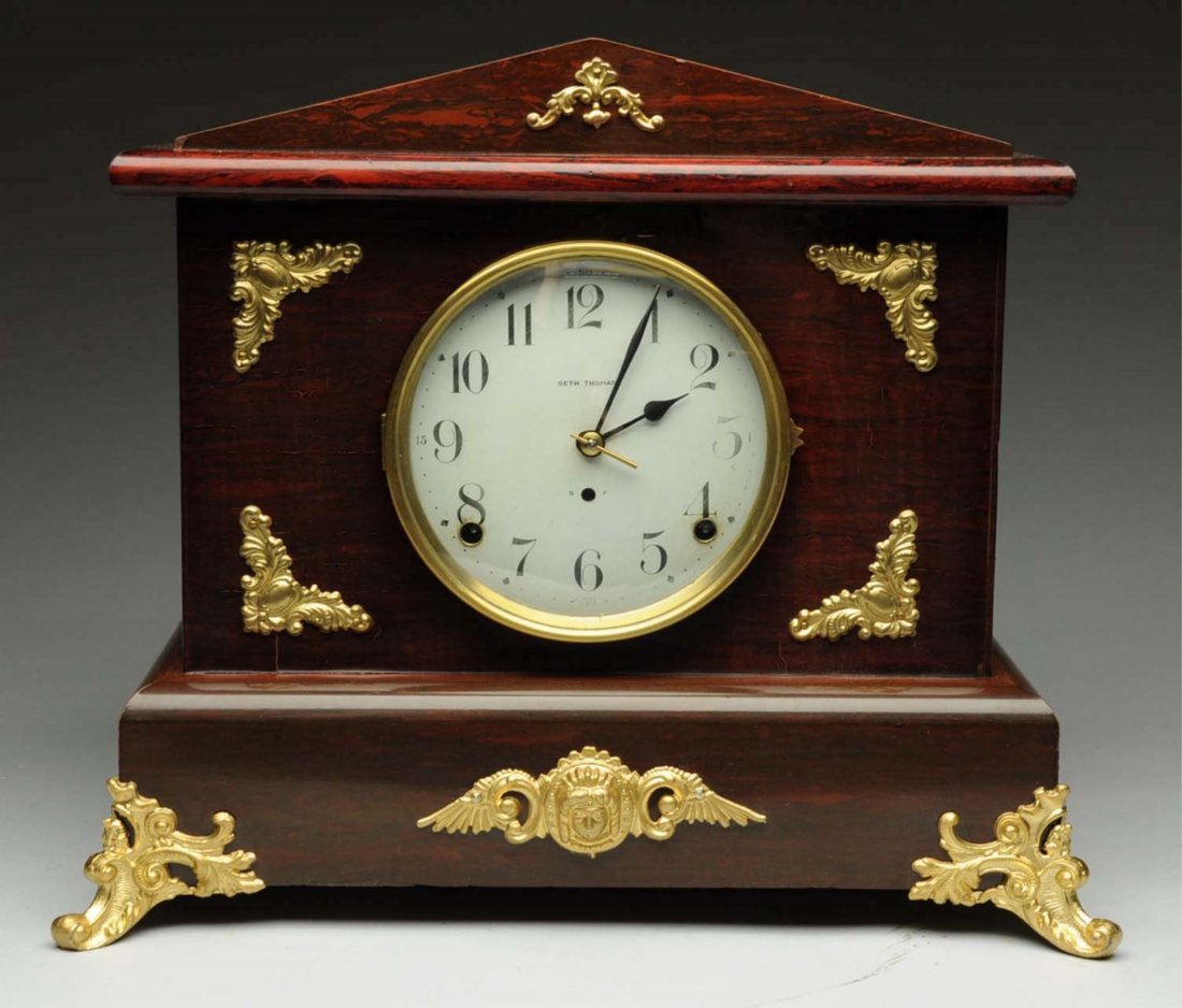 Wooden Seth Thomas Shelf Clock.: This Seth Thomas clock is in great condition and has a decorated front glass panel. Condition (Very Good Plus). Size 23 - 1/2" T.