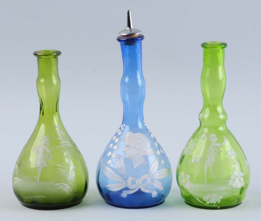 Lot of 3: Barber Bottles.: Mary Gregory. Two in green glass and one in blue. Two with children and one with a lady. One with a stopper and all with pontils. Condition (Excellent). Size 8" T.
