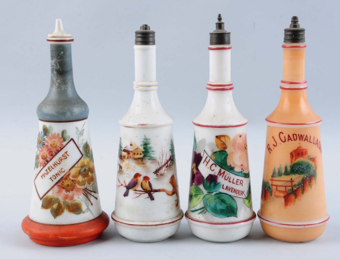 Lot of 4: Vintage Barber Bottles in Milk Glass.: Lot includes: one with church, one with house and two floral. All with stoppers. No damages or repairs. Condition (Excellent). Size Largest: 10 - 1/2" T.