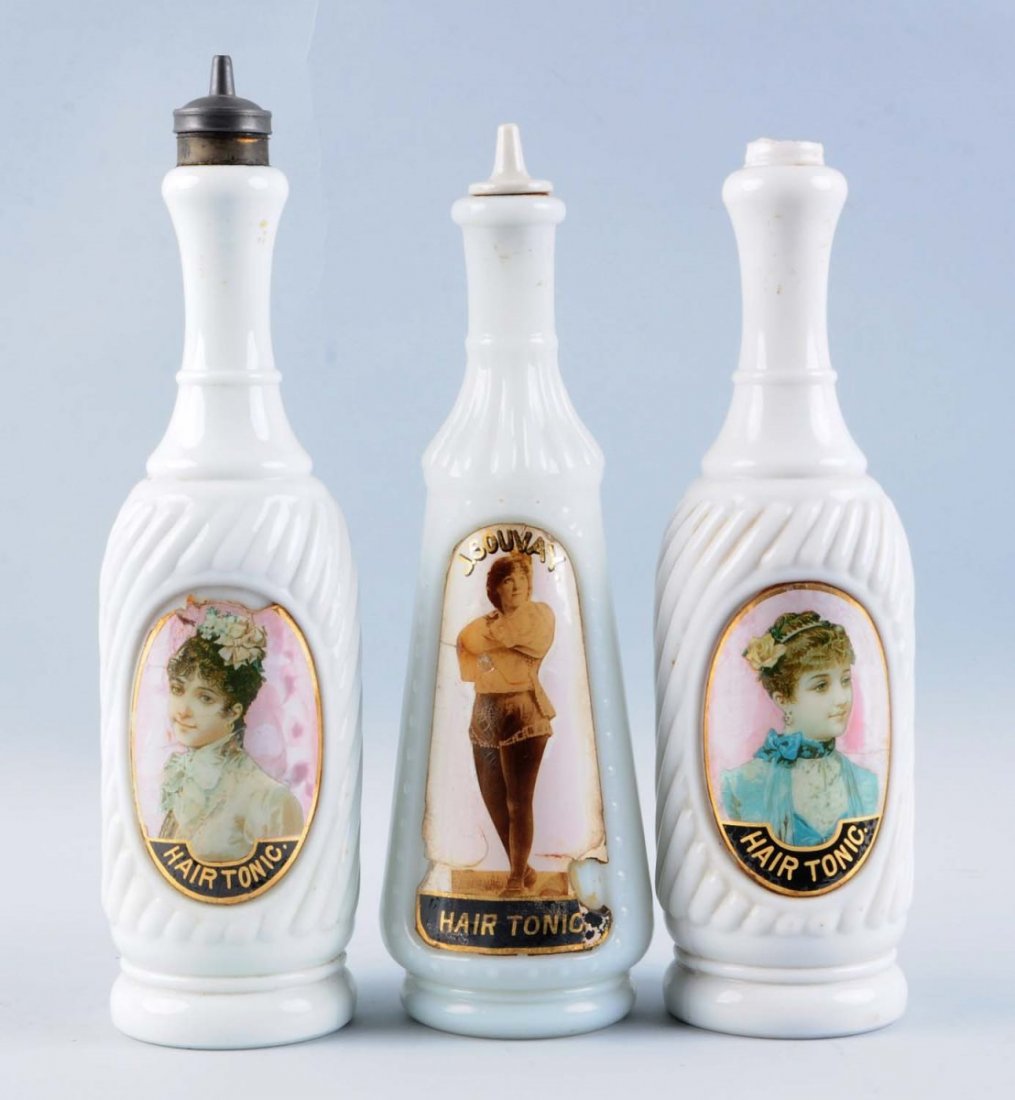 Lot of 3: Vintage Barber Bottles.: In milk glass with reverse painted images of pretty ladies. All three bottles were hair tonic bottles, two of which have loss to areas of the reverse painting, and the last with a crack at the three o