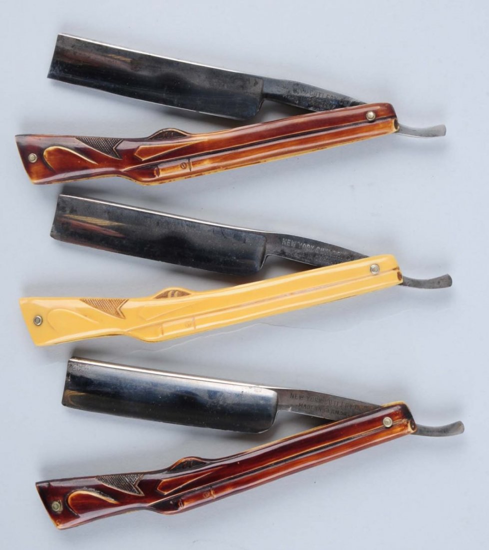 Lot of 3: Rare Figural Shotgun Razors.: Lot includes: a New York Cutlery Co. unusual figural shotgun razor measuring 5-3/4" closed with "New York Cutlery Co Made in Germany" and "WOW" on front and back tangs, and handled in yellow celluloid