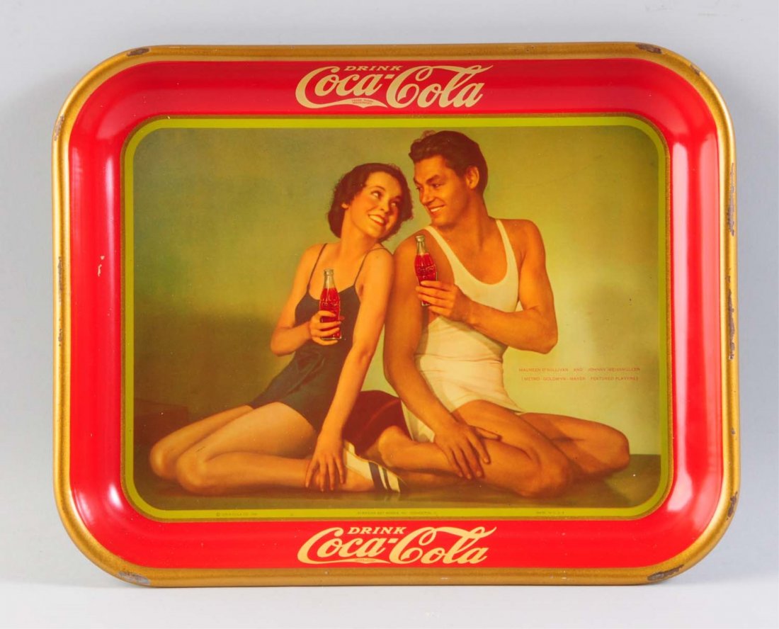 1934 Coca - Cola Serving Tray.: This tray has larger scrapes and nicks to the gold rim. The image area is very clean and bright. Condition (Very Good Plus). Size 13" L.